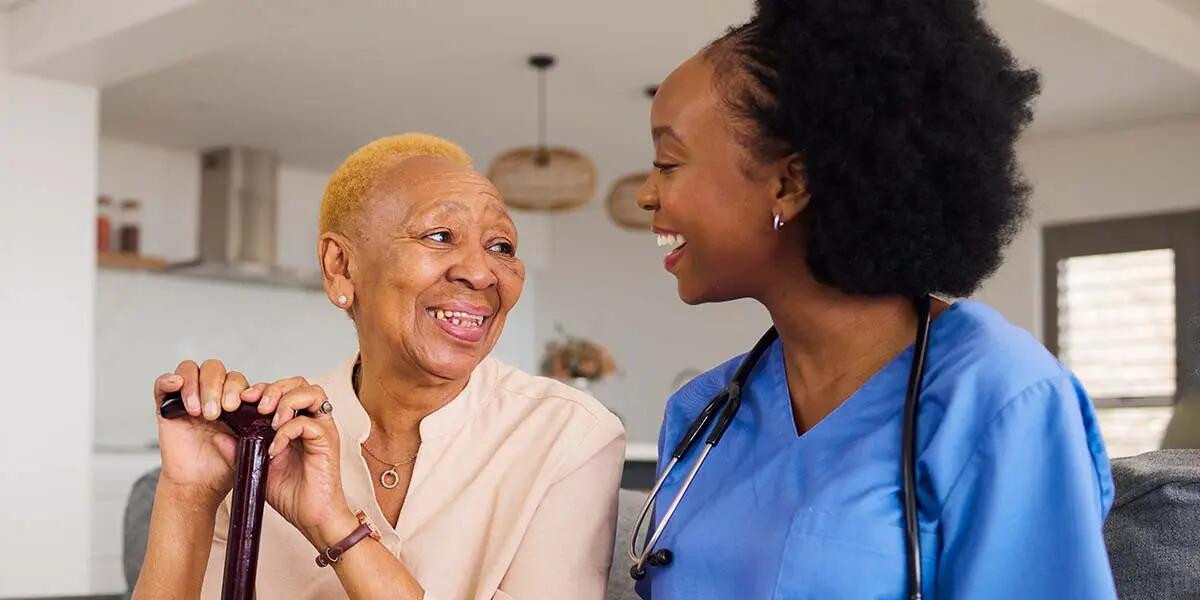 elderly woman with a cane with a nurse