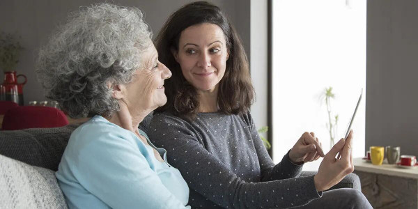 young woman with elderly woman smiling