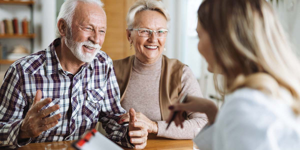 older couple consulting with younger healthcare worker