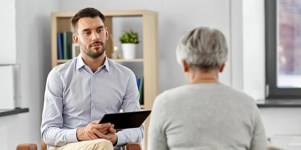 man inteviewing elderly patient