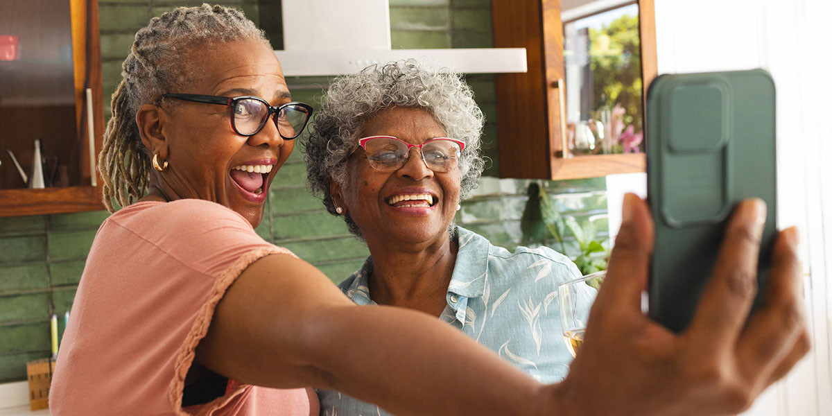 older adult women posing together for a selfie