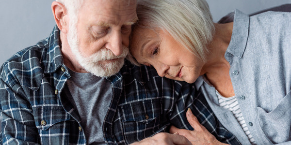 elderly couple sitting together for comfort
