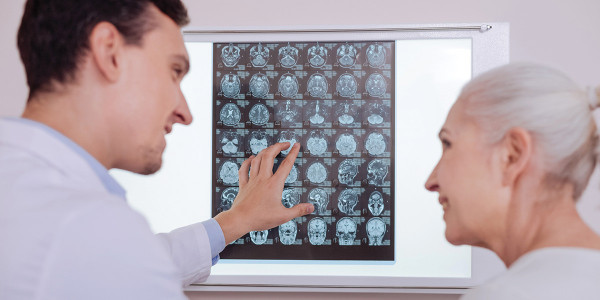 doctor discussing brain scans with elderly woman