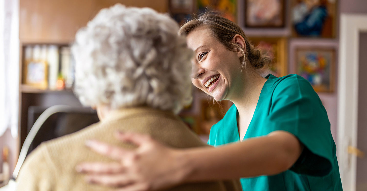 A nurse smiling at an older woman