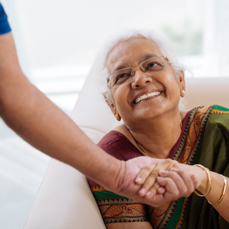 Smiling woman shaking a Doctor's hand